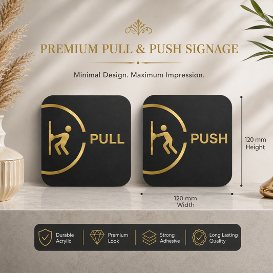 Two black premium acrylic pull and push signage panels with gold icons and text, displayed on a beige surface with decorative dried grass and leaves. The image includes dimension markers showing 120 mm height and width, and a feature banner at the bottom highlighting durable acrylic, premium lock, strong adhesive, and long-lasting quality.